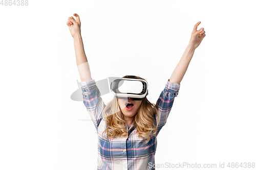 Image of Emotional caucasian woman using VR-headsed isolated on white studio background, technologies. Winning