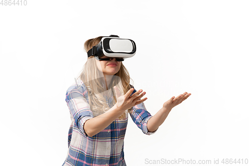 Image of Emotional caucasian woman using VR-headsed isolated on white studio background, technologies. Scared