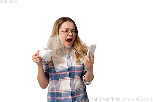 Image of Emotional caucasian woman using smartphone isolated on white studio background, technologies. Scared screaming