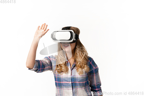 Image of Emotional caucasian woman using VR-headsed isolated on white studio background, technologies. Greeting