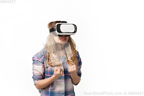 Image of Emotional caucasian woman using VR-headsed isolated on white studio background, technologies. Scared