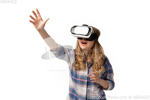 Image of Emotional caucasian woman using VR-headsed isolated on white studio background, technologies. Touching