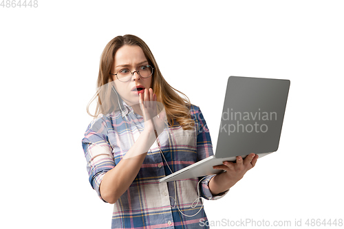 Image of Emotional caucasian woman using laptop on white studio background, technologies. Disguasted rejecting