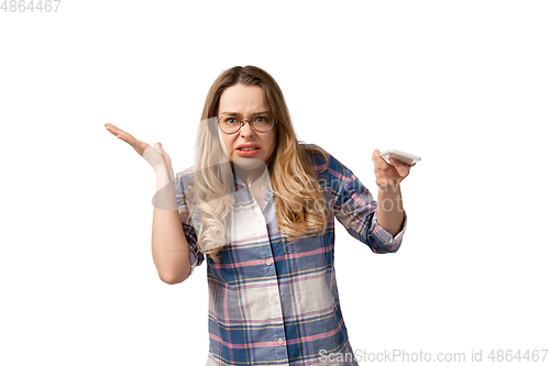 Image of Emotional caucasian woman using smartphone isolated on white studio background, technologies. Disguasted