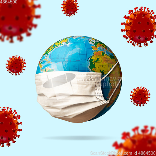 Image of 3D-illustration of COVID-19 coronavirus colored red spreading near around planet Earth wearing face mask, concept of pandemic, protection
