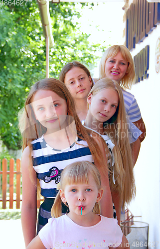 Image of Girls of different ages and growth. Feminine children and adults