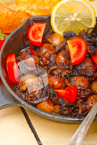 Image of Baby cuttle fish roasted on iron skillet