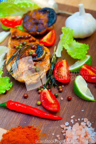 Image of wood fired hoven cooked chicken breast on wood board