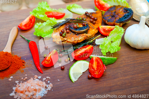 Image of wood fired hoven cooked chicken breast on wood board