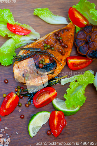 Image of wood fired hoven cooked chicken breast on wood board