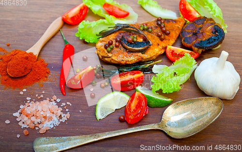 Image of wood fired hoven cooked chicken breast on wood board