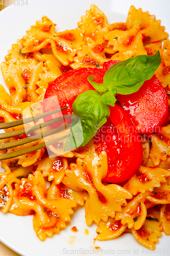 Image of Italian pasta farfalle butterfly bow-tie and tomato sauce