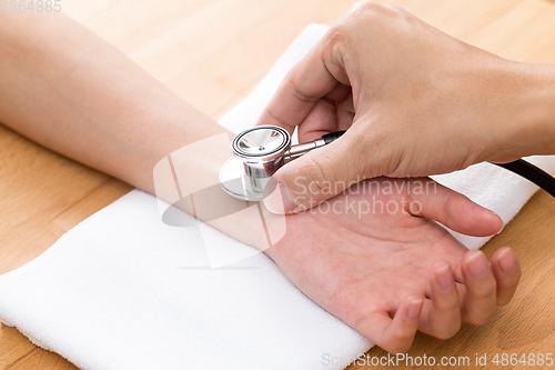 Image of Chinese Doctor checking patients pulse rate 