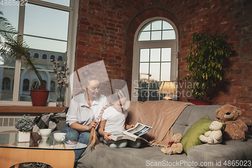 Image of Mother and daughter during self-insulation at home while quarantined, family time cozy and comfort