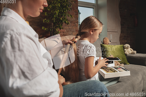 Image of Mother and daughter during self-insulation at home while quarantined, family time cozy and comfort