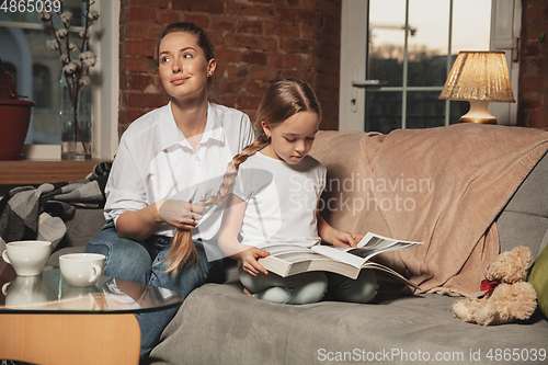 Image of Mother and daughter during self-insulation at home while quarantined, family time cozy and comfort