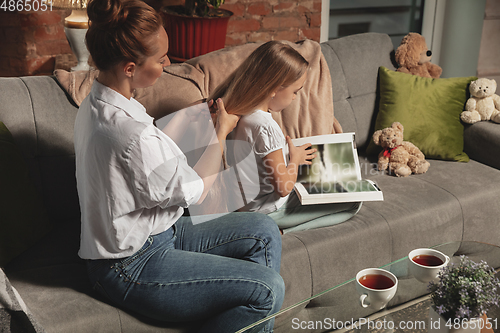 Image of Mother and daughter during self-insulation at home while quarantined, family time cozy and comfort