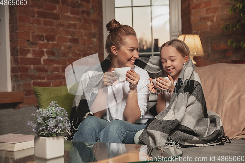 Image of Mother and daughter during self-insulation at home while quarantined, family time cozy and comfort