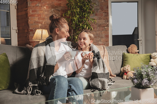 Image of Mother and daughter during self-insulation at home while quarantined, family time cozy and comfort