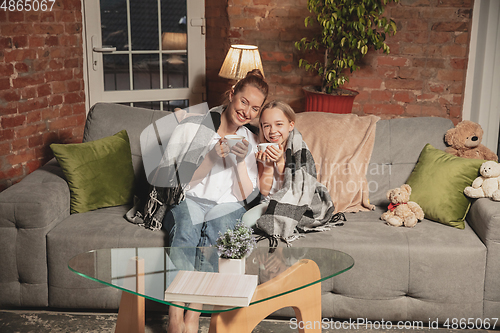 Image of Mother and daughter during self-insulation at home while quarantined, family time cozy and comfort