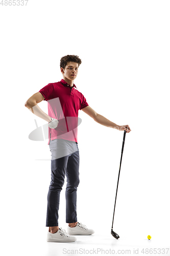 Image of Golf player in a red shirt training, practicing isolated on white studio background