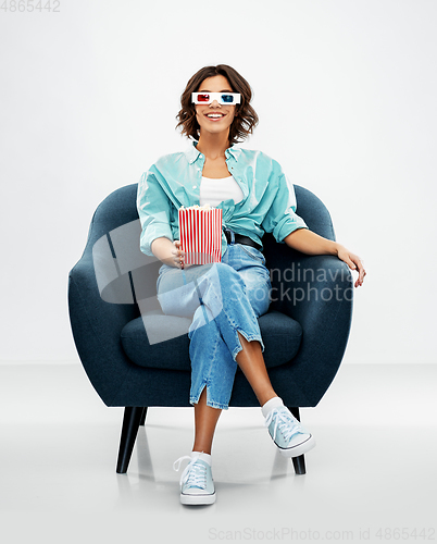 Image of woman in 3d movie glasses with popcorn in chair