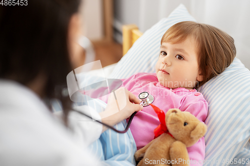 Image of doctor with stethoscope and sick girl in bed