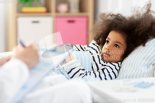 Image of doctor with clipboard and sick girl in bed at home