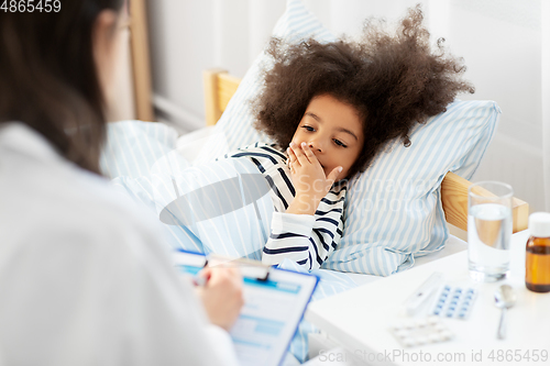 Image of doctor with clipboard and sick girl in bed at home