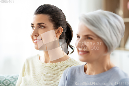 Image of portrait of old mother and adult daughter at home