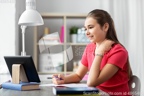 Image of student girl with tablet pc learning at home