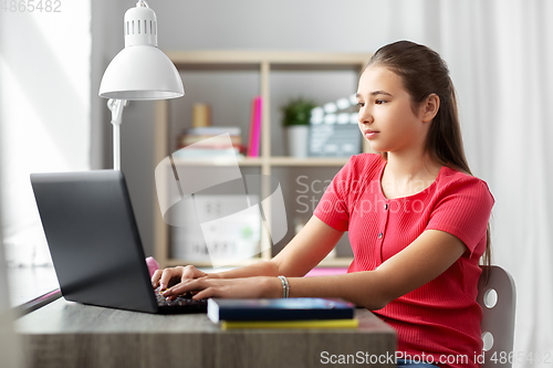 Image of student girl with laptop computer learning at home