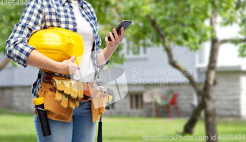 Image of woman or builder with phone and working tools