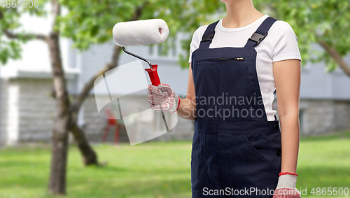 Image of close up of painter or builder with paint roller