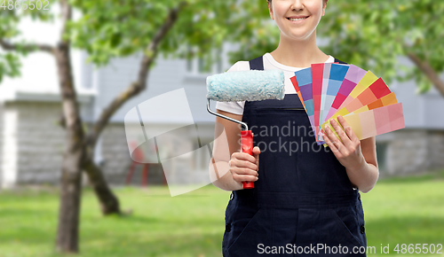 Image of close up of painter with roller and color charts