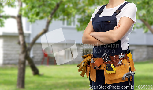 Image of woman or builder with working tools on belt