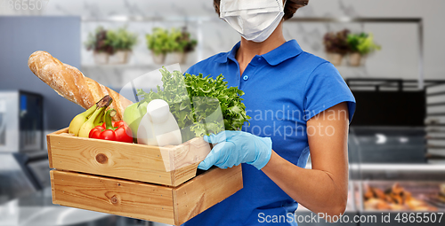 Image of delivery woman in face mask with food in box