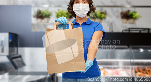 Image of delivery woman in face mask with paper bag