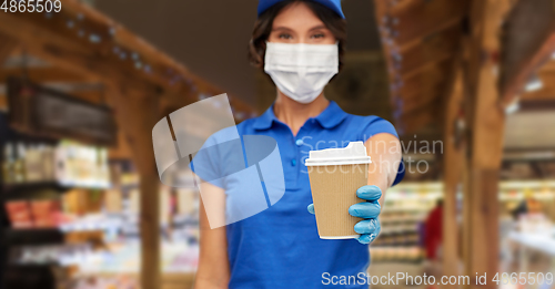 Image of saleswoman in face mask with takeaway coffee cup