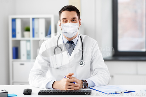 Image of male doctor in medical mask at hospital