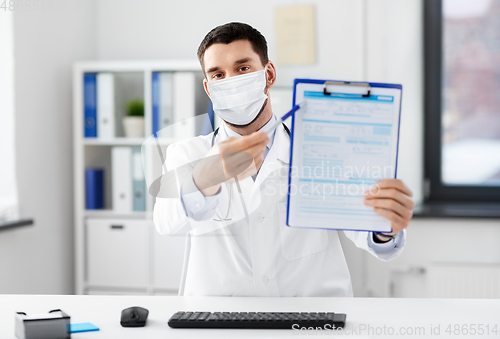 Image of doctor with clipboard having video call at clinic