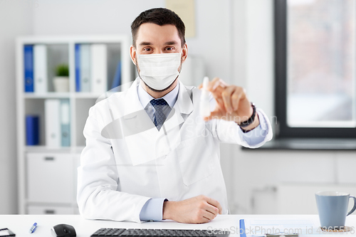 Image of smiling male doctor with medicine at hospital