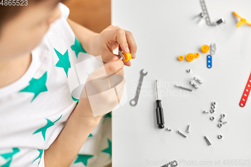 Image of little boy playing with airplane toy at home