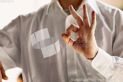 Image of Close up of caucasian male hands, working in office, business, people