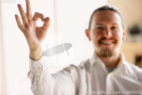 Image of Close up of caucasian male hands, working in office, business, people