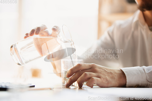 Image of Close up of caucasian male hands, working in office, business, people