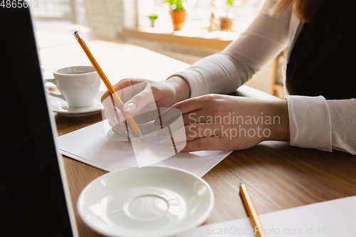 Image of Close up of caucasian female hands, working in office, business, people