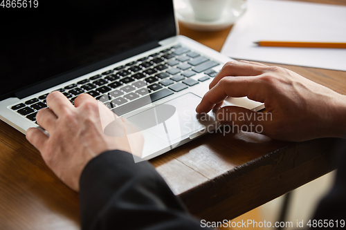 Image of Close up of caucasian male hands, working in office, business, people