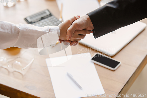 Image of Close up of caucasian human hands, shaking, working in office, business, people