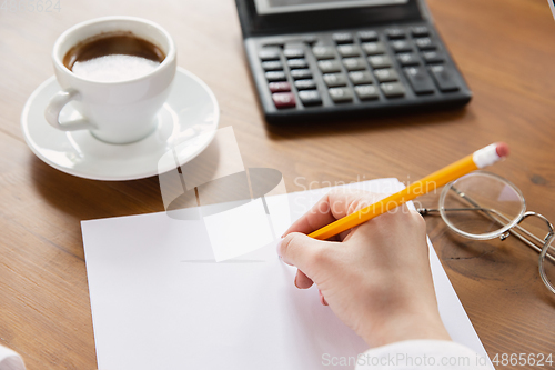 Image of Close up of caucasian female hands, working in office, business, people